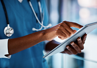 Healthcare employee using digital tools to improve patient care