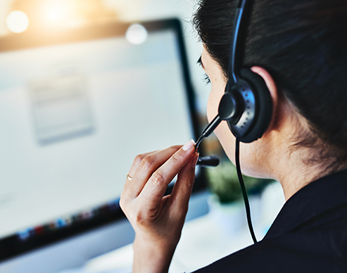 Administrative employee wearing a headset and scheduling clients