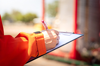 Close-up of an individual filling out an application for a factory job