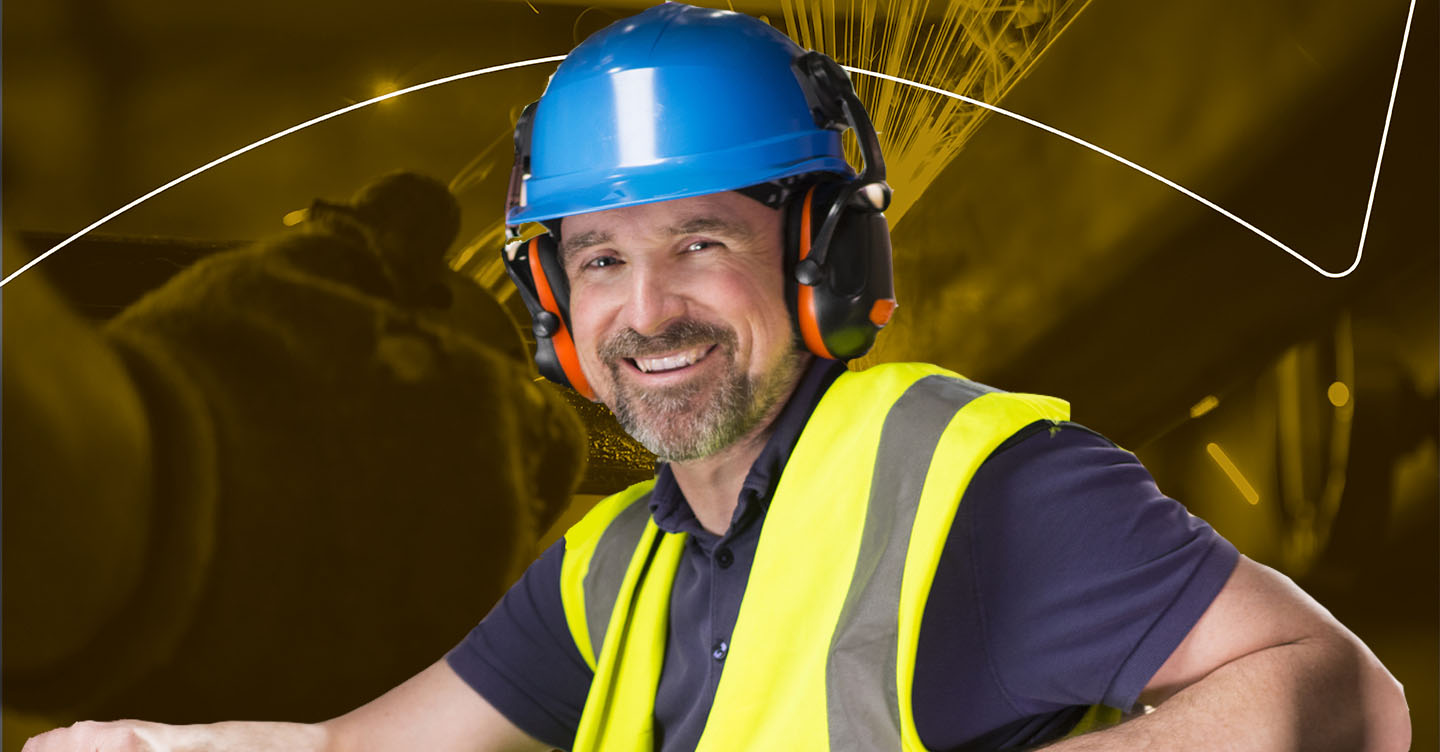 Temp agency employee wearing safety ear plugs, hat, and vest